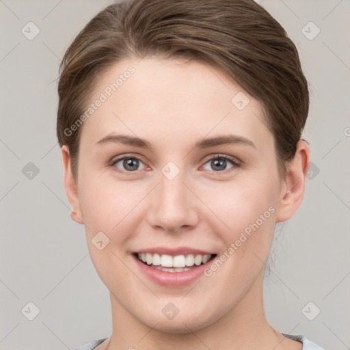 Joyful white young-adult female with short  brown hair and grey eyes