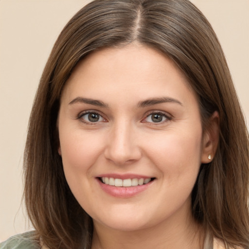 Joyful white young-adult female with long  brown hair and brown eyes