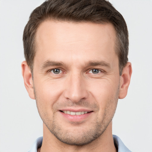 Joyful white young-adult male with short  brown hair and brown eyes