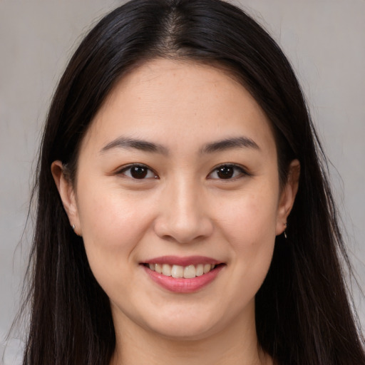 Joyful white young-adult female with long  brown hair and brown eyes