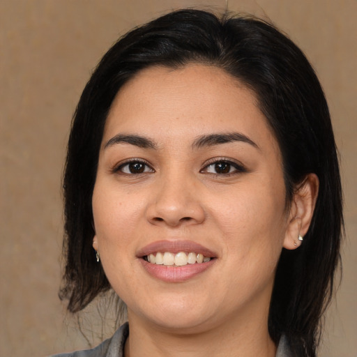 Joyful white young-adult female with medium  black hair and brown eyes