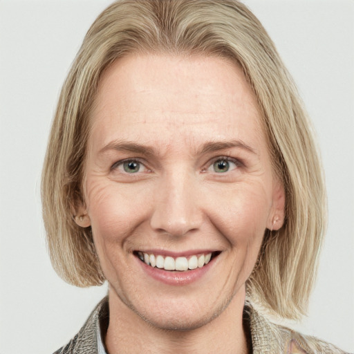 Joyful white adult female with medium  brown hair and blue eyes