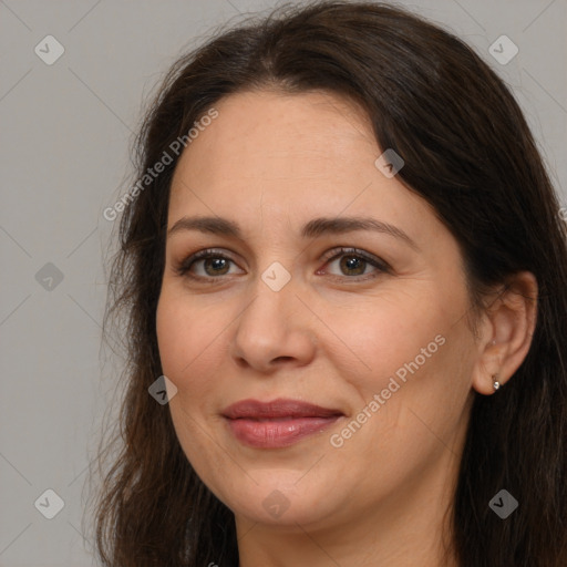 Joyful white adult female with long  brown hair and brown eyes