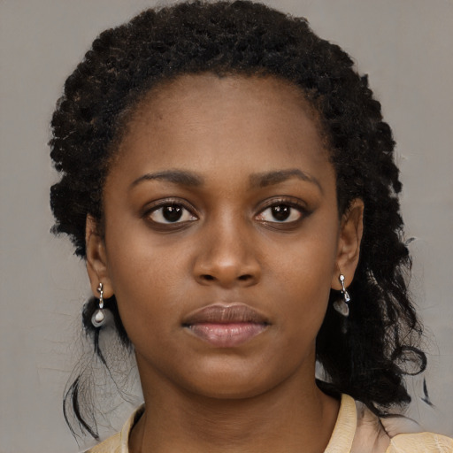 Neutral black young-adult female with medium  brown hair and brown eyes