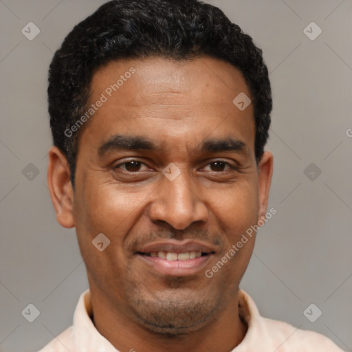 Joyful latino adult male with short  brown hair and brown eyes