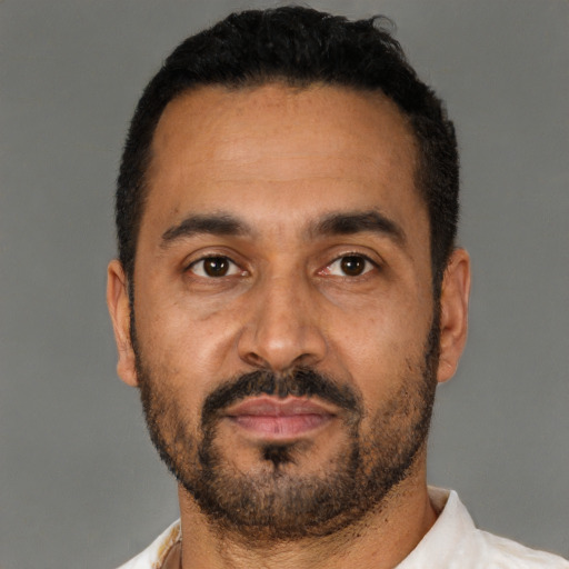 Neutral latino adult male with short  black hair and brown eyes