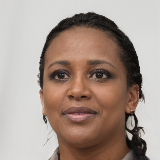 Joyful black young-adult female with long  black hair and brown eyes
