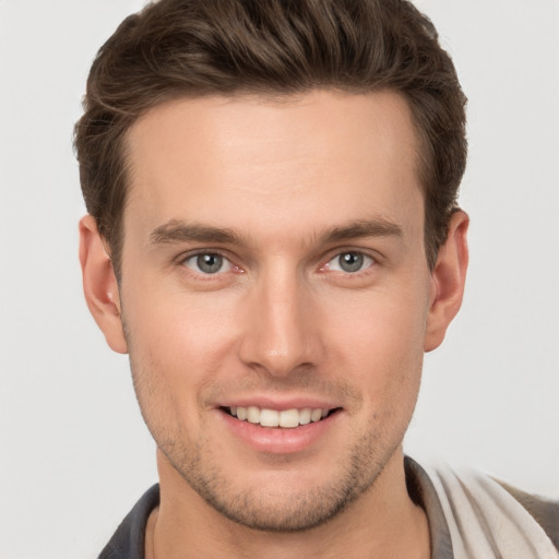 Joyful white young-adult male with short  brown hair and brown eyes