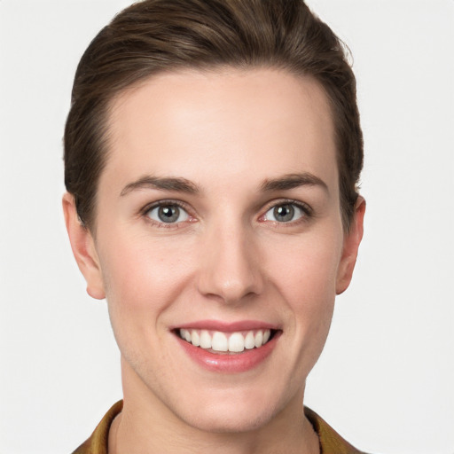 Joyful white young-adult female with short  brown hair and grey eyes