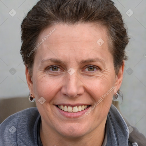 Joyful white adult female with short  brown hair and grey eyes