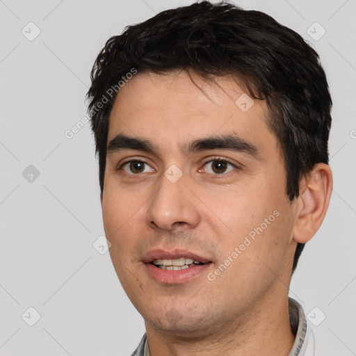 Joyful white young-adult male with short  black hair and brown eyes