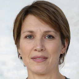 Joyful white adult female with medium  brown hair and grey eyes