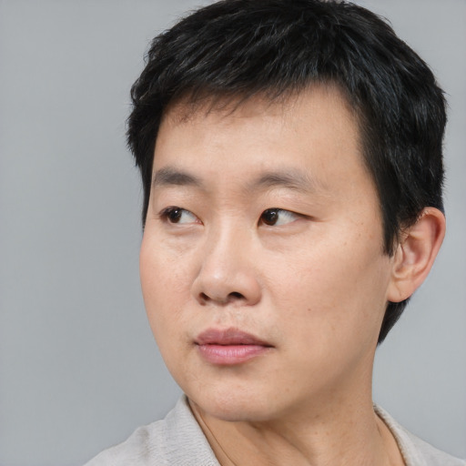 Neutral asian young-adult male with short  black hair and brown eyes