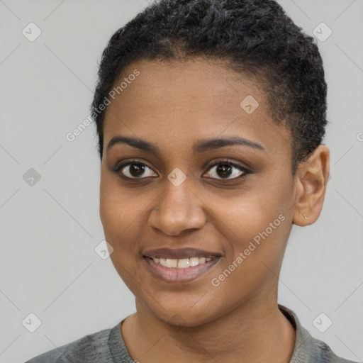 Joyful black young-adult female with short  black hair and brown eyes