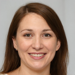 Joyful white adult female with medium  brown hair and brown eyes