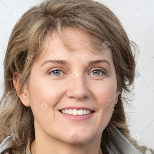 Joyful white young-adult female with medium  brown hair and blue eyes