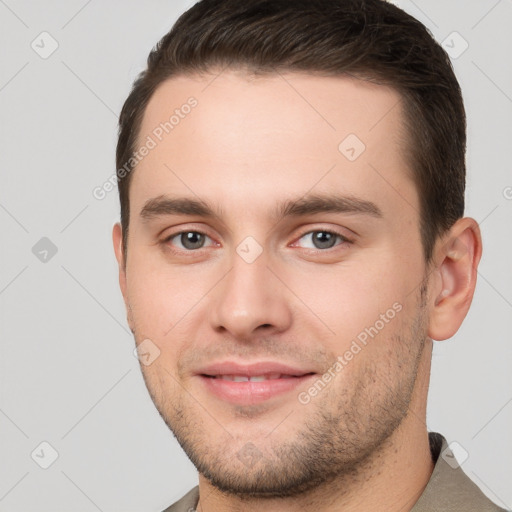 Joyful white young-adult male with short  brown hair and brown eyes