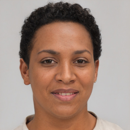 Joyful black young-adult female with short  brown hair and brown eyes