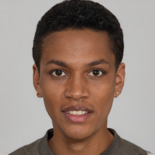 Joyful black young-adult male with short  black hair and brown eyes