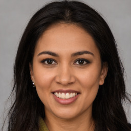 Joyful latino young-adult female with long  brown hair and brown eyes