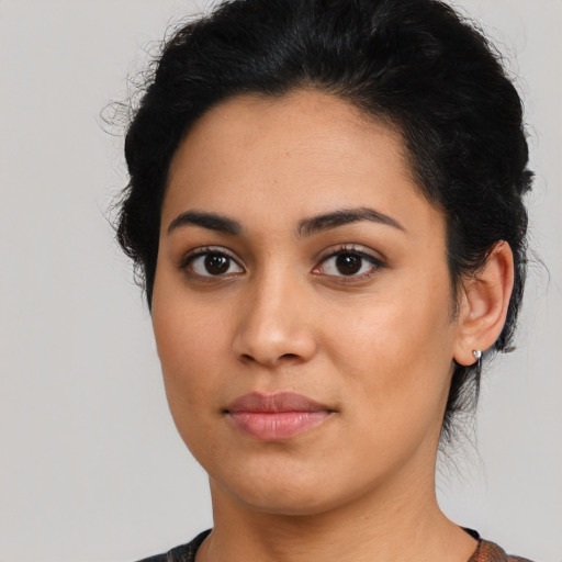 Joyful latino young-adult female with short  brown hair and brown eyes