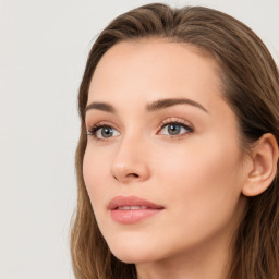 Joyful white young-adult female with long  brown hair and blue eyes