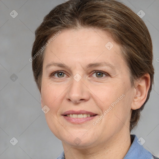 Joyful white adult female with short  brown hair and grey eyes