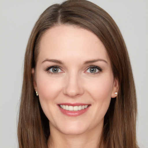 Joyful white young-adult female with long  brown hair and grey eyes