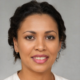 Joyful latino young-adult female with medium  brown hair and brown eyes