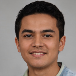 Joyful latino young-adult male with short  brown hair and brown eyes