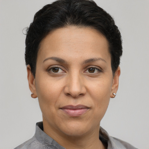 Joyful latino adult female with short  brown hair and brown eyes