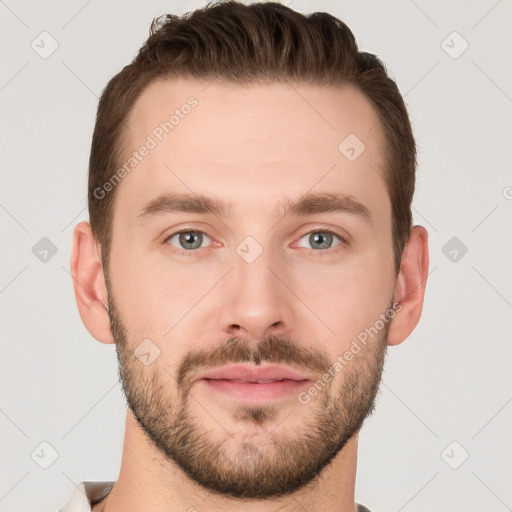 Joyful white young-adult male with short  brown hair and grey eyes