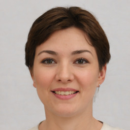 Joyful white young-adult female with short  brown hair and brown eyes