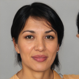 Joyful white adult female with medium  brown hair and brown eyes