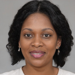 Joyful black adult female with medium  brown hair and brown eyes