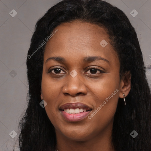 Joyful black young-adult female with long  black hair and brown eyes