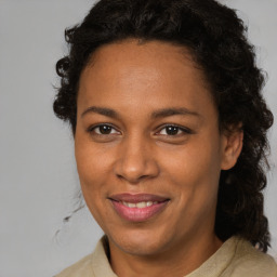 Joyful black adult female with medium  brown hair and brown eyes