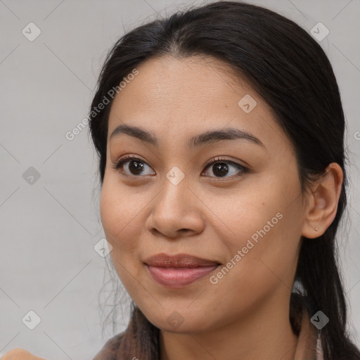 Joyful asian young-adult female with long  brown hair and brown eyes