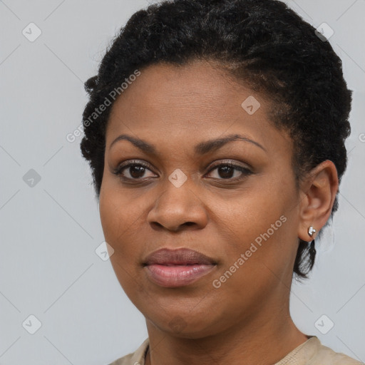 Joyful black young-adult female with short  black hair and brown eyes