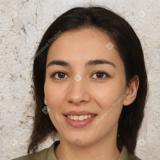 Joyful latino young-adult female with medium  brown hair and brown eyes