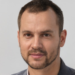 Joyful white adult male with short  brown hair and brown eyes