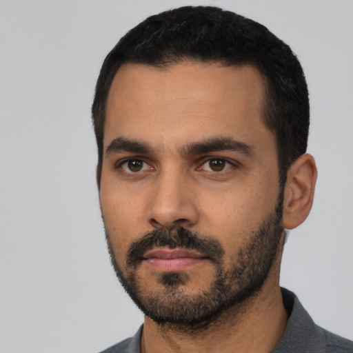 Neutral latino young-adult male with short  black hair and brown eyes