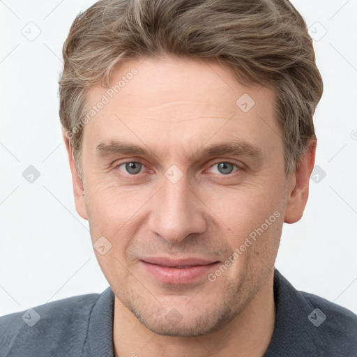 Joyful white adult male with short  brown hair and grey eyes