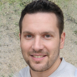 Joyful white young-adult male with short  brown hair and brown eyes