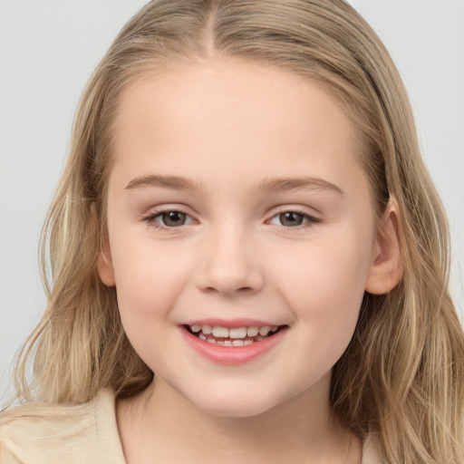 Joyful white child female with long  brown hair and brown eyes