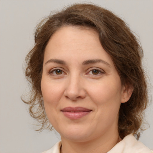 Joyful white adult female with medium  brown hair and brown eyes