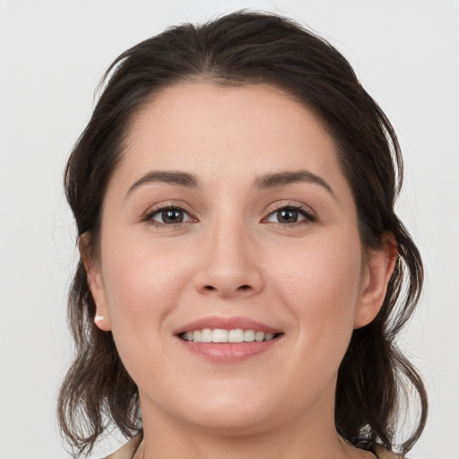 Joyful white young-adult female with medium  brown hair and brown eyes