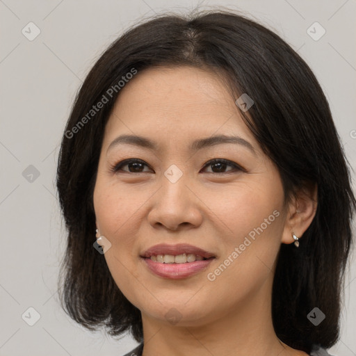 Joyful asian adult female with medium  brown hair and brown eyes