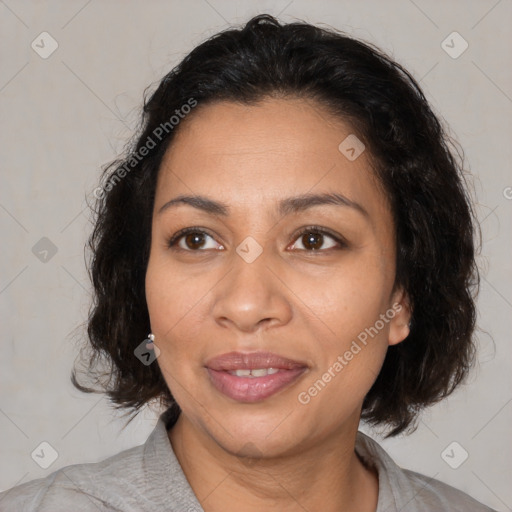 Joyful latino adult female with medium  brown hair and brown eyes