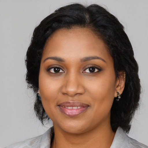Joyful black young-adult female with medium  black hair and brown eyes